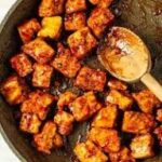Golden tofu bites in a pan